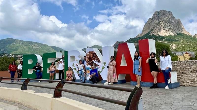 읽는 큰 표시 앞에서 포즈를 취하는 학생들 : Bernal